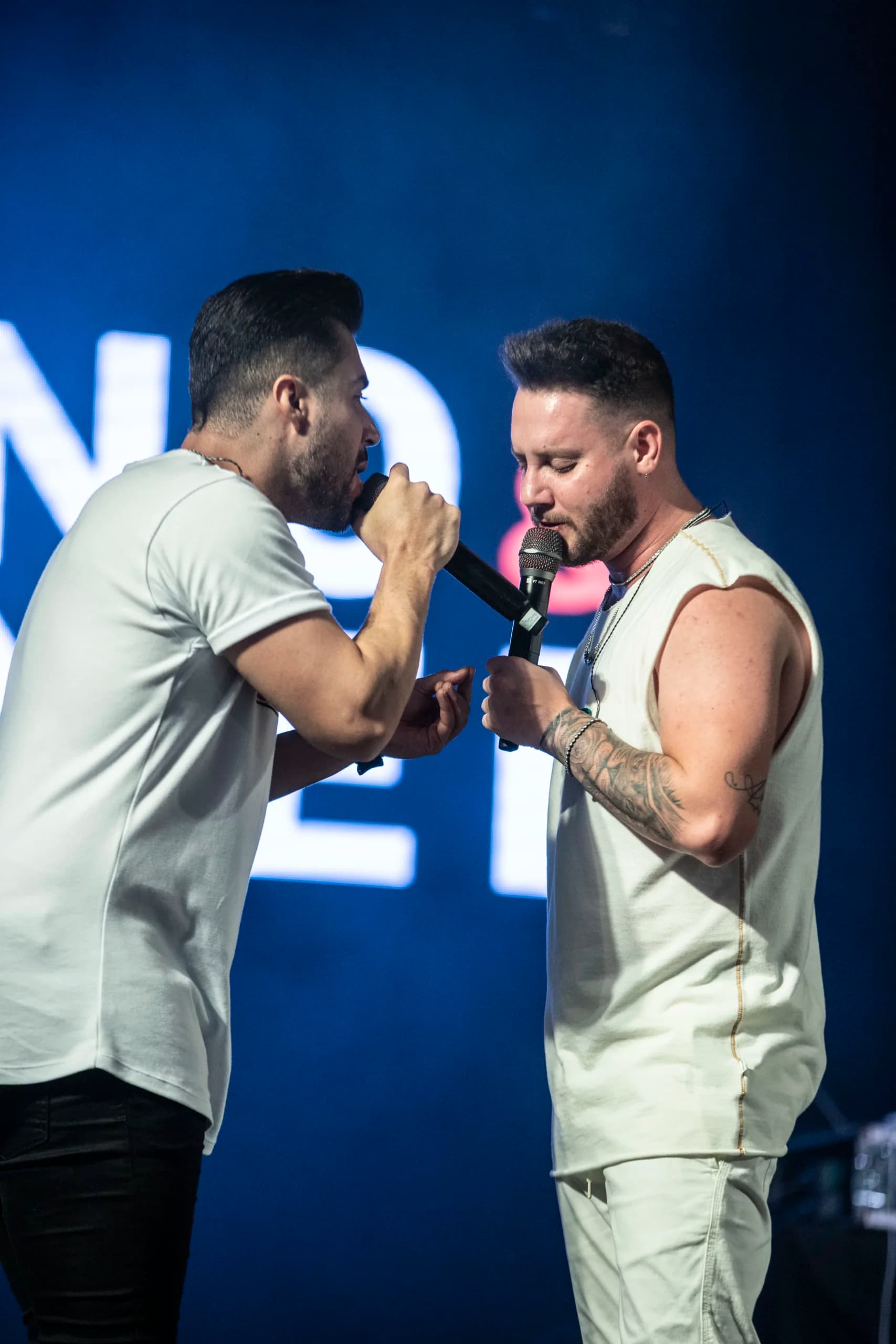Bruno e Denner cantando juntos no palco